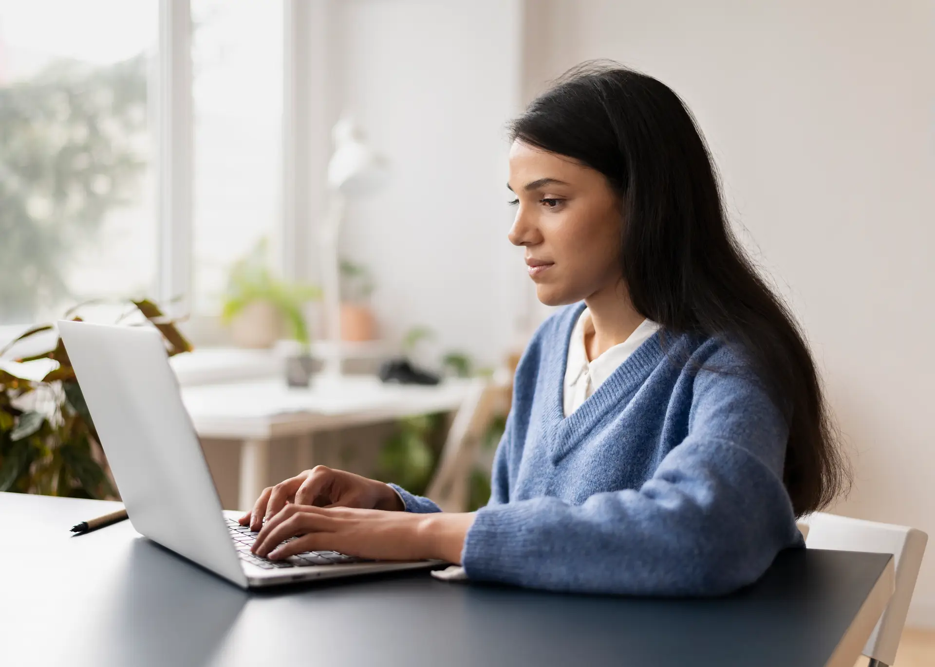 woman at desk using a laptop