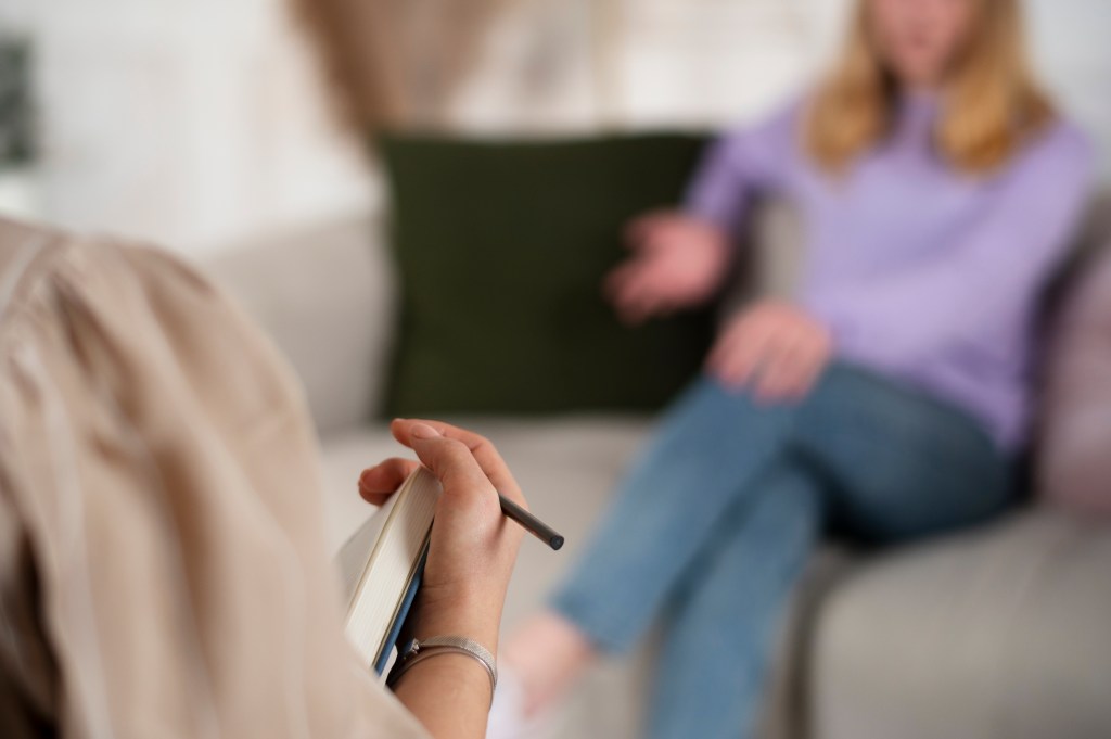 young girl talking to a therapist