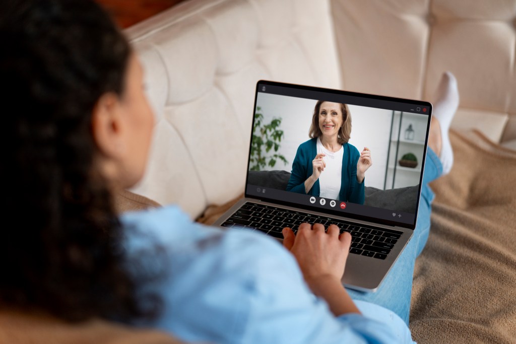 woman on couch with laptop on her lap
